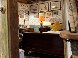 A bedroom with a bed and a dresser at the property in Bovey Tracey