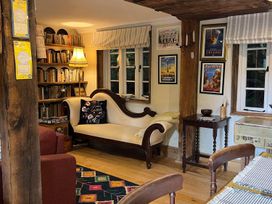 A living room with a couch and bookshelves at  in Bovey Tracey