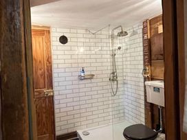 A bathroom with a shower and toilet at The Old Barn in Bovey Tracey