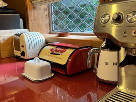 A kitchen counter with a toaster bread box and espresso machine at 