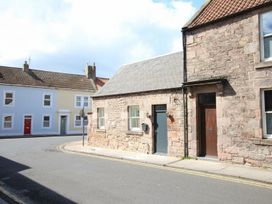 A street view of a stone building and neighboring houses at Newly Refurbished Cottage, sleeping 4 and Central, Berwick-Upon-Tweed