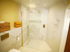 A bathroom with a shower and towels at Newly Refurbished Cottage, sleeping 4 and Central Berwick-Upon-Tweed