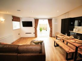 A living room with a television and dining table at Newly Refurbished Cottage, sleeping 4 and Central Berwick-Upon-Tweed