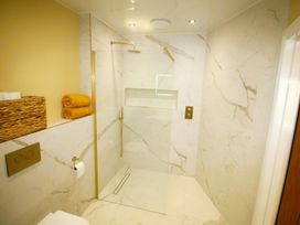 A bathroom featuring a shower, towels, and a toilet at Newly Refurbished Cottage, sleeping 4 and Central Berwick-Upon-Tweed