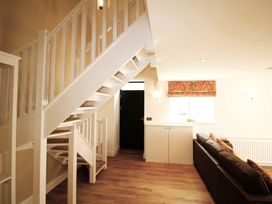 A living room with a staircase and sofa at Newly Refurbished Cottage, sleeping 4 and Central Berwick-Upon-Tweed
