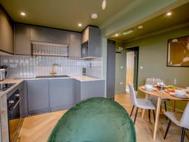 A kitchen with appliances and dining area at 1 Bedroom Apartment, sleeping 3 with balcony and pet friendly, Carbis Bay
