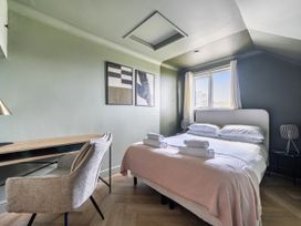 A bedroom with a bed, desk, and window at 1 Bedroom Apartment, sleeping 3 with balcony and pet friendly, Carbis Bay
