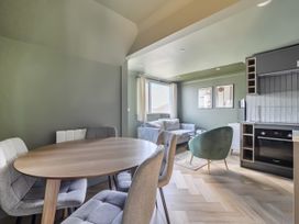 A living room with dining area and kitchen in 1 Bedroom Apartment, sleeping 3 with balcony and pet friendly, Carbis Bay
