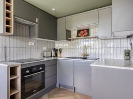 A kitchen with cabinets, sink, stove, and appliances at 1 Bedroom Apartment, sleeping 3 with balcony and pet friendly, Carbis Bay