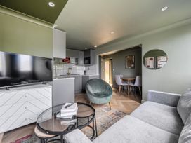 A living room with a sofa and television in 1 Bedroom Apartment, sleeping 3 with balcony and pet friendly, Carbis Bay