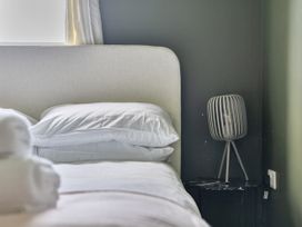 A bedroom with a bed and bedside table at 1 Bedroom Apartment, sleeping 3 with balcony and pet friendly, Carbis Bay