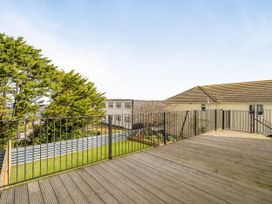 An outdoor area with wooden decking and railing at 1 Bedroom Apartment, sleeping 3 with balcony and pet friendly, Carbis Bay
