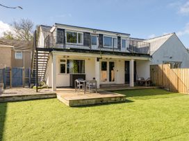 A house with a balcony and stairs leading to the garden at 1 Bedroom Apartment, sleeping 3 with balcony and pet friendly, Carbis Bay