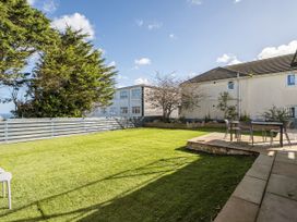 A garden with grass, outdoor furniture and trees at 1 Bedroom Apartment, sleeping 3 with balcony and pet friendly in Carbis Bay