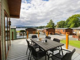 An outdoor seating area with a table and chairs at 19 Pony Meadow near Troutbeck Bridge