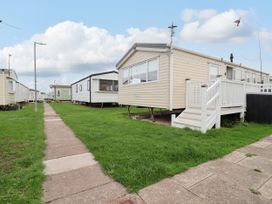 An outdoor area with mobile homes and a pathway at B54