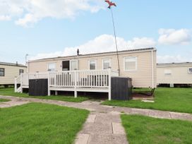 A mobile home with a deck and pathway at B54