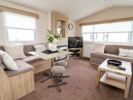A living room with a sofa and a television at B54