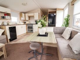 A kitchen with a table and sofa at B54 
