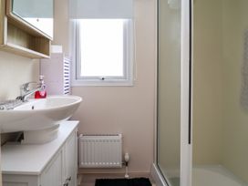 A bathroom with a sink and shower at B54