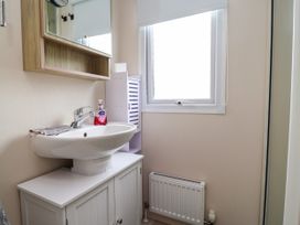 A bathroom with a sink and mirror at B54