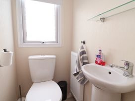 A bathroom with a toilet and sink at B54