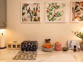 A kitchen counter with a bread box and fruit bowl at Muddy Boots – La Petite Mews in Kirby Stephen