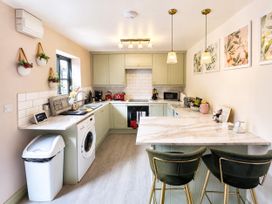 A kitchen with appliances and a countertop at Muddy Boots – La Petite Mews Kirby Stephen