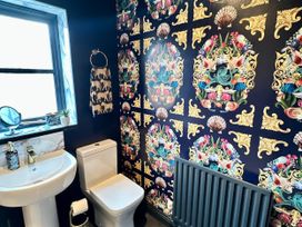 A bathroom with a sink and toilet at Muddy Boots – La Petite Mews in Kirby Stephen