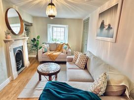 A living room with two sofas and a coffee table at Muddy Boots – Arcade Royale in Kirby Stephen