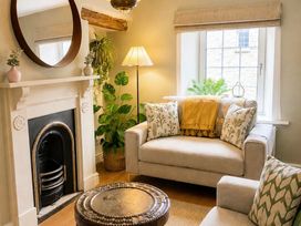 A living room with a sofa and coffee table at Muddy Boots – Arcade Royale in Kirby Stephen