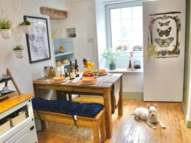 A dining room with a table set for meals at Muddy Boots – Arcade Royale in Kirby Stephen