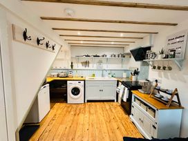 A kitchen with a sink and stove at Muddy Boots – Arcade Royale, Kirby Stephen