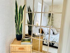 A bedroom featuring a bed, mirror, and dresser at Muddy Boots – Arcade Royale in Kirby Stephen