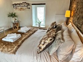 A bedroom with a bed and pillows at Muddy Boots – Arcade Royale in Kirby Stephen