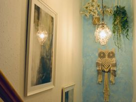 A hallway with owl wall art and framed pictures at Muddy Boots – Arcade Royale Kirby Stephen