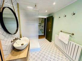 A bathroom with a sink and shower at Muddy Boots – Arcade Royale, Kirby Stephen