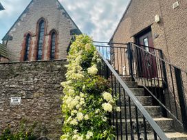 An outdoor view of a building with stairs and a plant at Muddy Boots – Scarpa in Kirkby Stephen