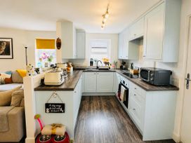 A kitchen with countertop, appliances and shelving at Muddy Boots – Scarpa in Kirkby Stephen