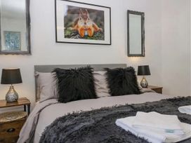 A bedroom with a bed and bedside table at Muddy Boots – Scarpa in Kirkby Stephen