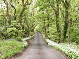A road surrounded by trees and flowers at Muddy Boots – Scarpa Kirkby Stephen