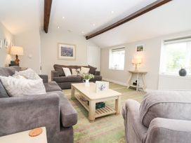 A living room with sofas and a coffee table at Peewit Barn in Moreton-in-Marsh