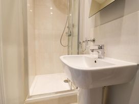 A bathroom with a shower and sink at Peewit Barn in Moreton-in-Marsh