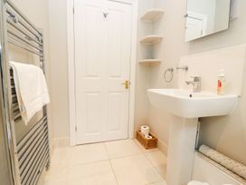 A bathroom with a sink and towel rail at Peewit Barn Moreton-in-Marsh