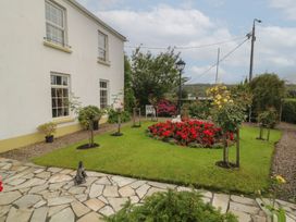 A garden with flowers and a path at Bruckless Rest Fine Country Dining B&B in Bruckless