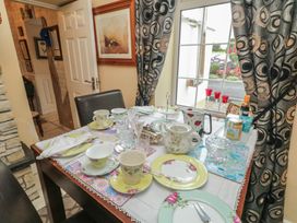 A dining table set with tea cups and a milk jug at Bruckless Rest Fine Country Dining B&B in Bruckless