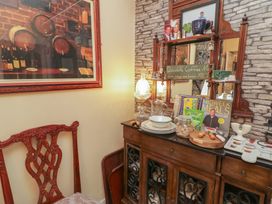 A dining room with a wooden cabinet and decorative items at Bruckless Rest Fine Country Dining B&B in Bruckless