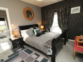 A bedroom with a bed and mirror at Bruckless Rest Fine Country Dining B&B Bruckless