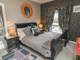 A bedroom with a bed and nightstand at Bruckless Rest Fine Country Dining B&B Bruckless