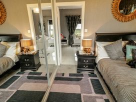 A bedroom with two beds and nightstands at Bruckless Rest Fine Country Dining B&B Bruckless